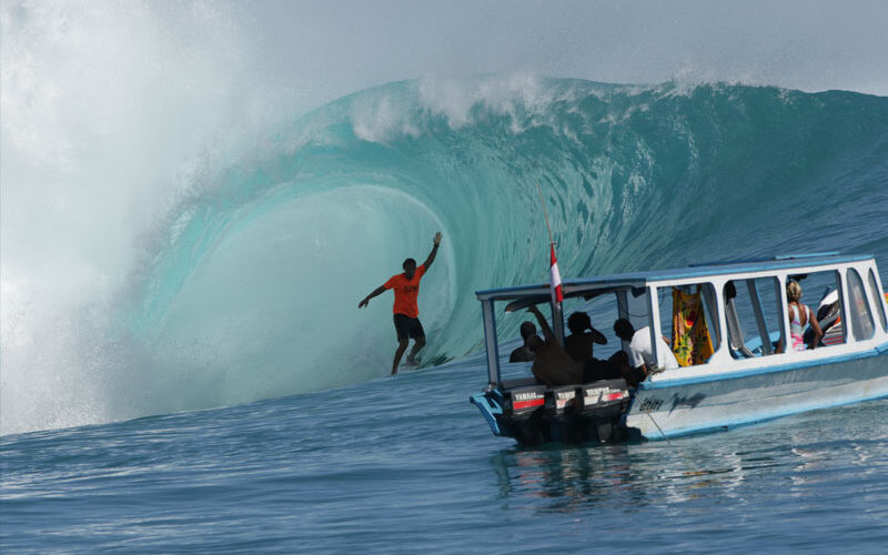 Surfer catchign a perfect wave at Kandui while staying on the Star Koat 2 surf charter boat in the Mentawai Islands