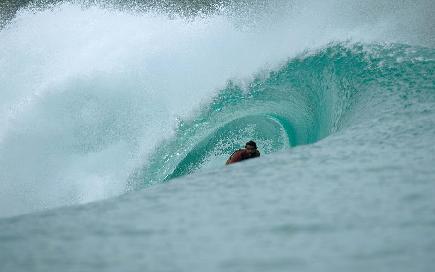 Surfer catching a perfect barrel at Ebay in the Mentawai Islands