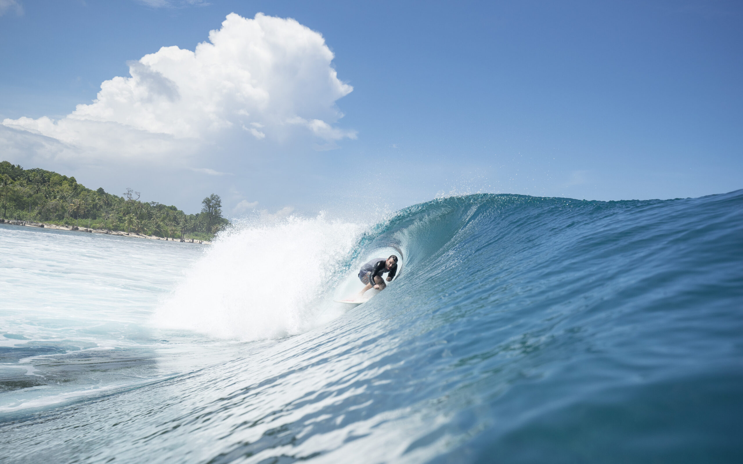 Surfer catching a perfect barrel at Lance's Left in the Mentawai Islands