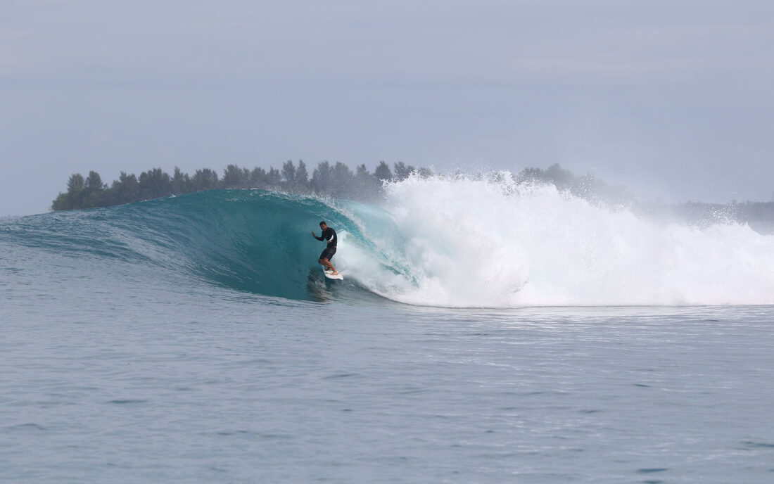Surfer catching a perfect barrel at Shadow Right in the Mentawai Islands