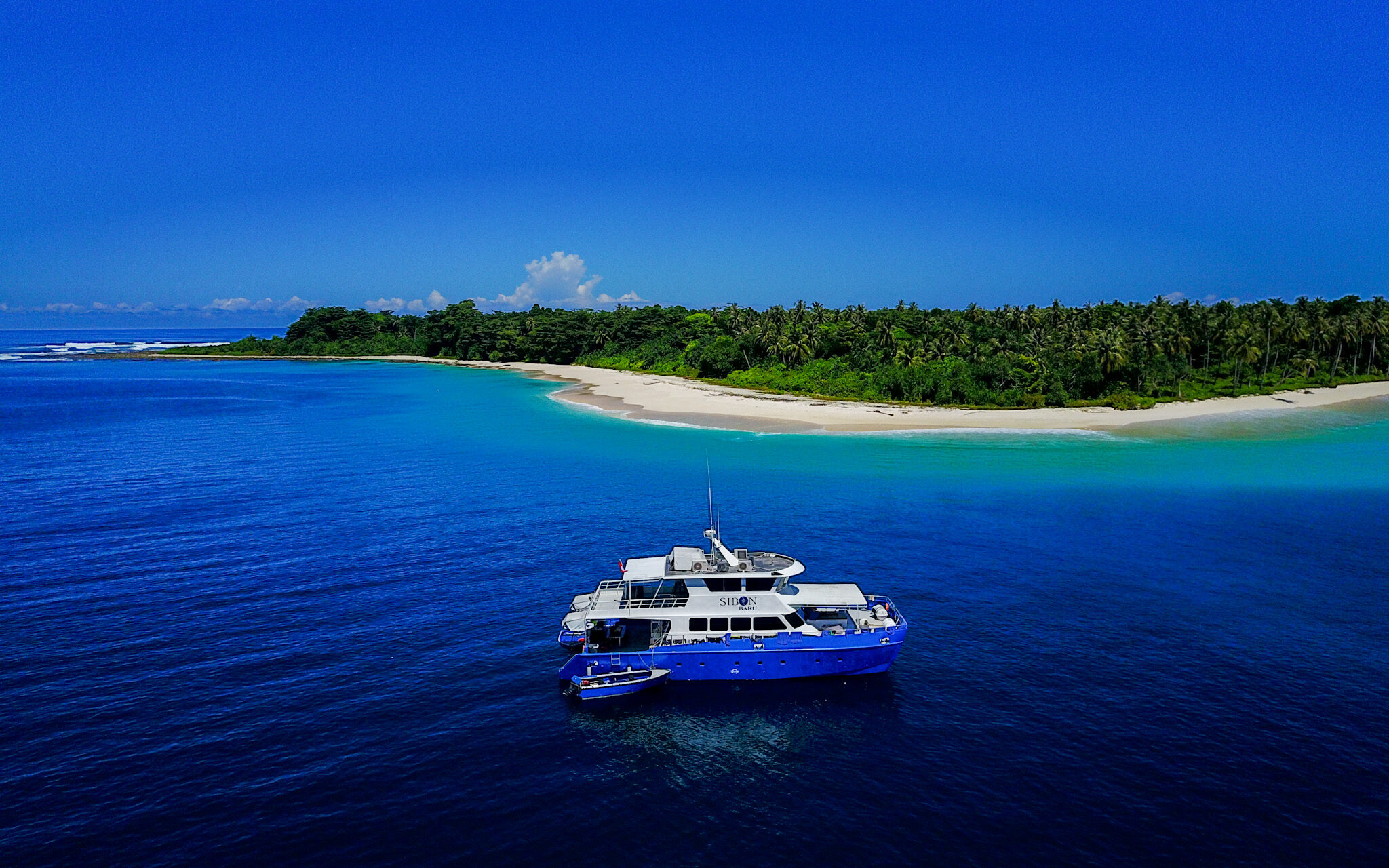 The Sibon Baru surf charter boat cruising in the Mentawai Islands while hunting for perfect waves and barrels